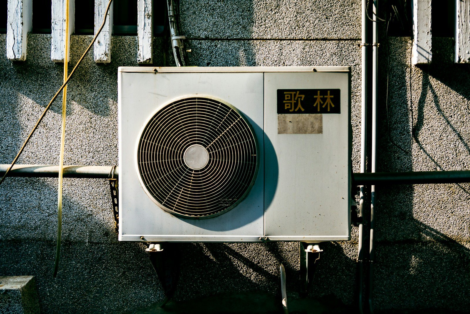 a wall mounted air conditioner mounted on the side of a building